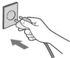 Hand holding a wall-mounted socket with an arrow indicating direction (no text or symbols)
