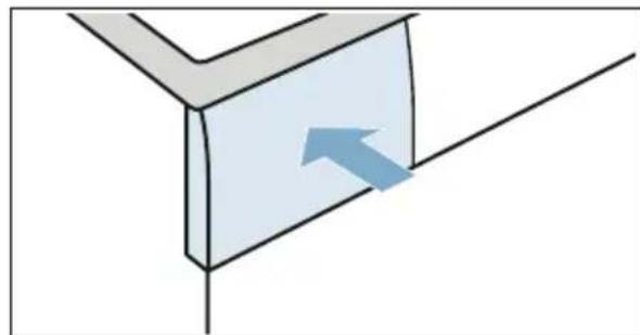 Simple 3D diagram of a corner block with an arrow indicating direction, no text or symbols.