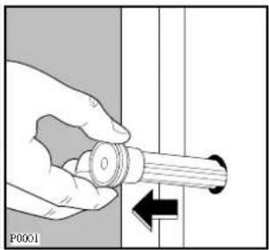 Hand holding a cylindrical mechanical component with a black arrow indicating direction (no text or symbols)