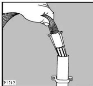 Illustration of a hand connecting a cable to a mechanical component (no text or symbols visible)