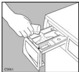 Line drawing of a hand inserting a component into a drawer (no text or symbols)