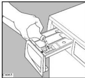 Illustration of a hand inserting a small component into a drawer (no text or symbols visible)