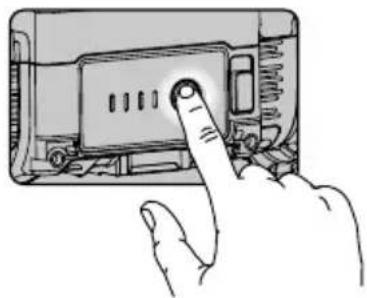 Hand inserting a button into a device casing (no text or symbols visible).