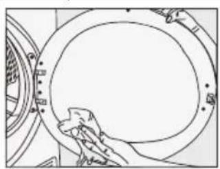 Line drawing of a hand cleaning a circular mechanical component (no text or symbols).