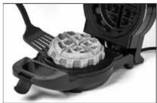 Close-up of a black waffle grater with open lid and side fork (no text or symbols visible)