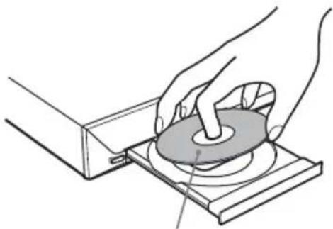 Illustration of hands operating a mechanical device with a circular component on a base (no text or symbols visible)