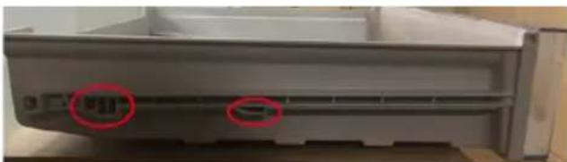Close-up of a gray electronic device casing with two red circular annotations highlighting features (no readable text or symbols)