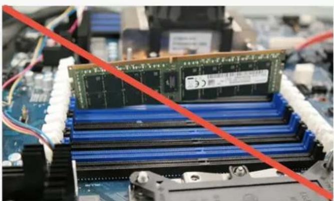 Close-up of a computer motherboard with a green RAM module and blue CPU socket, overlaid with a red diagonal line (no text or symbols visible)