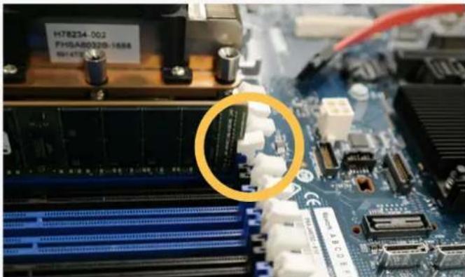 Close-up of a computer motherboard with visible slots, chips, and connectors (no readable text or symbols)