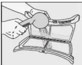 Illustration of a hand using a tool to clean or wash material inside a container (no text or symbols visible).