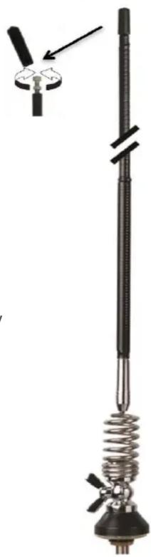 Diagram of a vertical antenna with a coiled spring and two blades, no text or symbols present