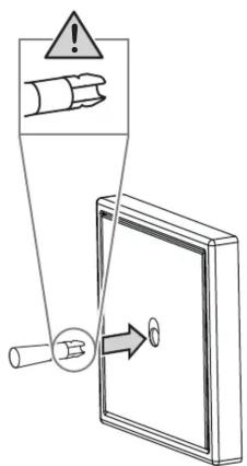 Safety warning diagram showing hand holding a device with warning symbol and directional arrow