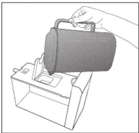Line drawing of a hand using a tool to lift a cylindrical object into a box (no text or symbols)
