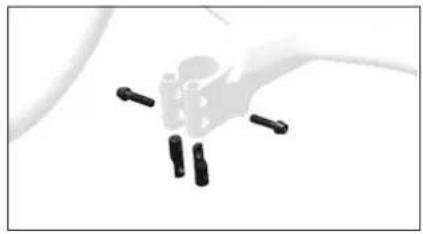 Close-up of a hand holding four black cylindrical pins (no text or symbols visible)