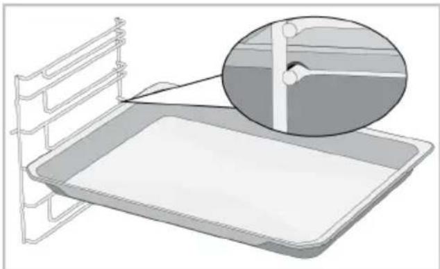 Illustration of a medical bed tray with a magnified inset showing internal structure (no text or symbols)