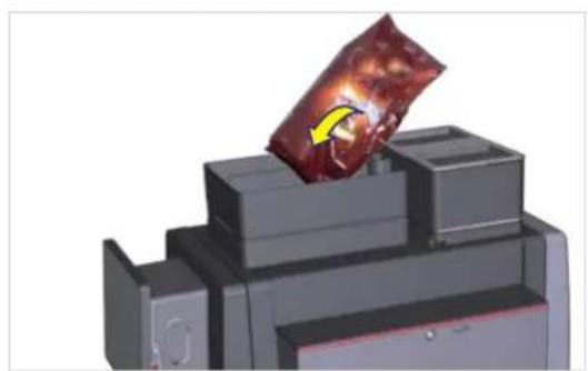 3D printer printer with a red packet being inserted into the top block (no visible text or symbols)