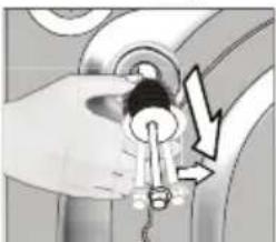 Hand holding a key inserted into a mechanical component with a lightning bolt symbol (no text or labels).