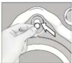 Close-up of a hand adjusting a circular component with an arrow pointing to it (no text or symbols visible).