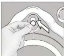 Hand holding a small circular object with an arrow pointing to it, against a plain background (no text or symbols).