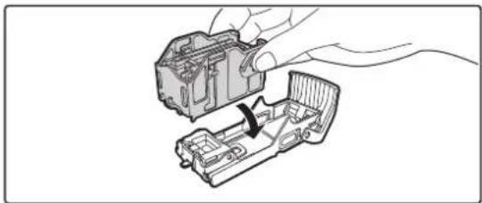 Illustration of a hand holding a mechanical component with a cable inserted into a housing (no text or symbols).