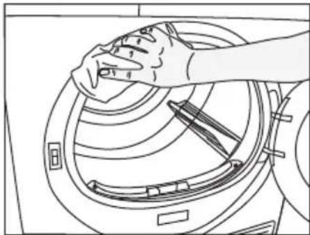 Line drawing of a hand cleaning a washing machine drum (no text or symbols)