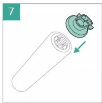 Diagram of a cylindrical device with internal components and a green arrow indicating direction (no text or symbols)