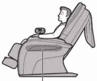 Line drawing of a person seated in a massage chair, viewed from the side (no text or symbols).