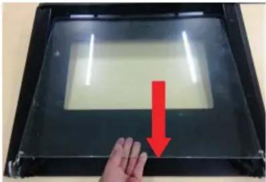 Hand pressing down on a transparent display panel with a red downward arrow indicating compression (no text or symbols visible).