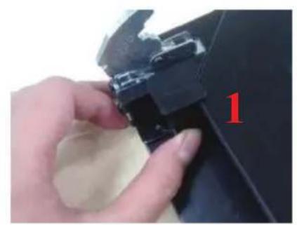 Close-up of a hand holding a small mechanical component, no visible text or symbols.