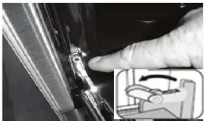 Close-up of a finger pressing a small component, with an inset showing a mechanical device (no visible text or symbols).