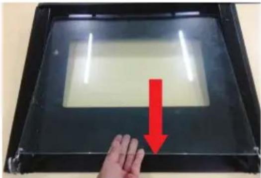 Hand pressing down on a transparent display panel with a red downward arrow indicating compression (no text or symbols visible).