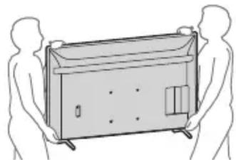 Line drawing of two human figures holding a rectangular device (no text or symbols)