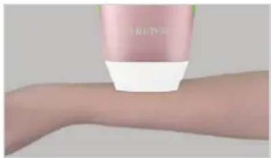 Close-up of a pink cosmetic product being held on a human forearm (no visible text or symbols)
