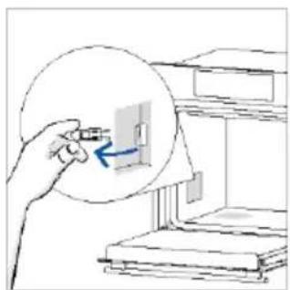 Illustration of a hand holding a small object inside a circular frame, with a blue arrow pointing to a device (no text or symbols present)