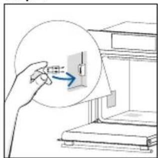 Illustration of a hand inserting a component into a device (no text or symbols visible)