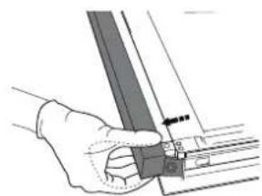 Hand holding a mechanical component with a ruler and bracket (no visible text or symbols).
