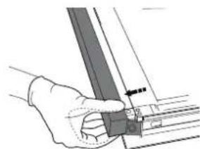 Hand holding a metal bracket with a small inset view of a mechanical part (no text or symbols visible).