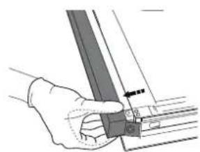Hand holding a metal bracket with a small inset view of a mechanical part.