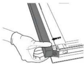 Hand holding a mechanical component with a ruler and bracket (no text or symbols visible)