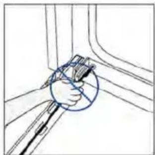 Hand holding a tool near a window frame, no text or symbols visible.