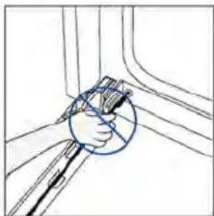 Hand holding a pen and ruler inside a vehicle (no text or symbols visible)