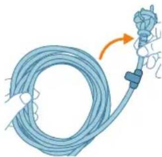 Illustration of a blue medical tube being inserted into a catheter, with an orange arrow indicating the insertion direction (no text or symbols present)