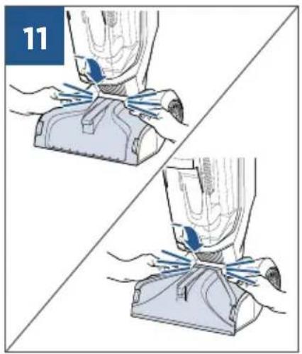 Illustration of two hands using a vacuum cleaner to lift a device, showing mechanical components and blue tool tips (no text or symbols)