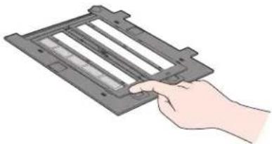 Hand holding a rectangular device with internal components, no visible text or symbols.