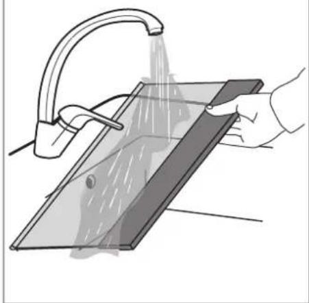 Illustration of a hand using a showerhead to clean or store floor tiles (no text or symbols visible).