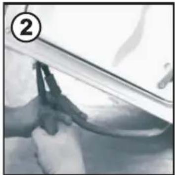 Close-up of hands cleaning a car window with a tool, no visible text or symbols.
