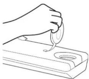 Line drawing of a hand using a spoon to apply liquid onto a tray (no text or symbols).
