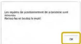 Les repêms de positionnement de la broderie sont directées Retirez-les et brodez le motif OK