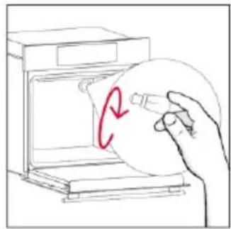 Hand holding a circular object inside an oven, with a red 'C' marking on the lid (no text or symbols present).