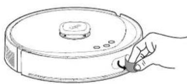 Line drawing of a hand holding a cleaning brush applying material to a circular robotic device (no text or symbols)